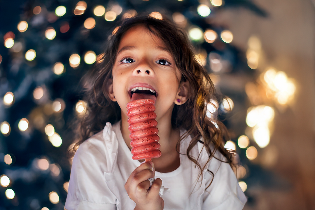 Photo by Patricia Prudente. Girl licking a popsicle.